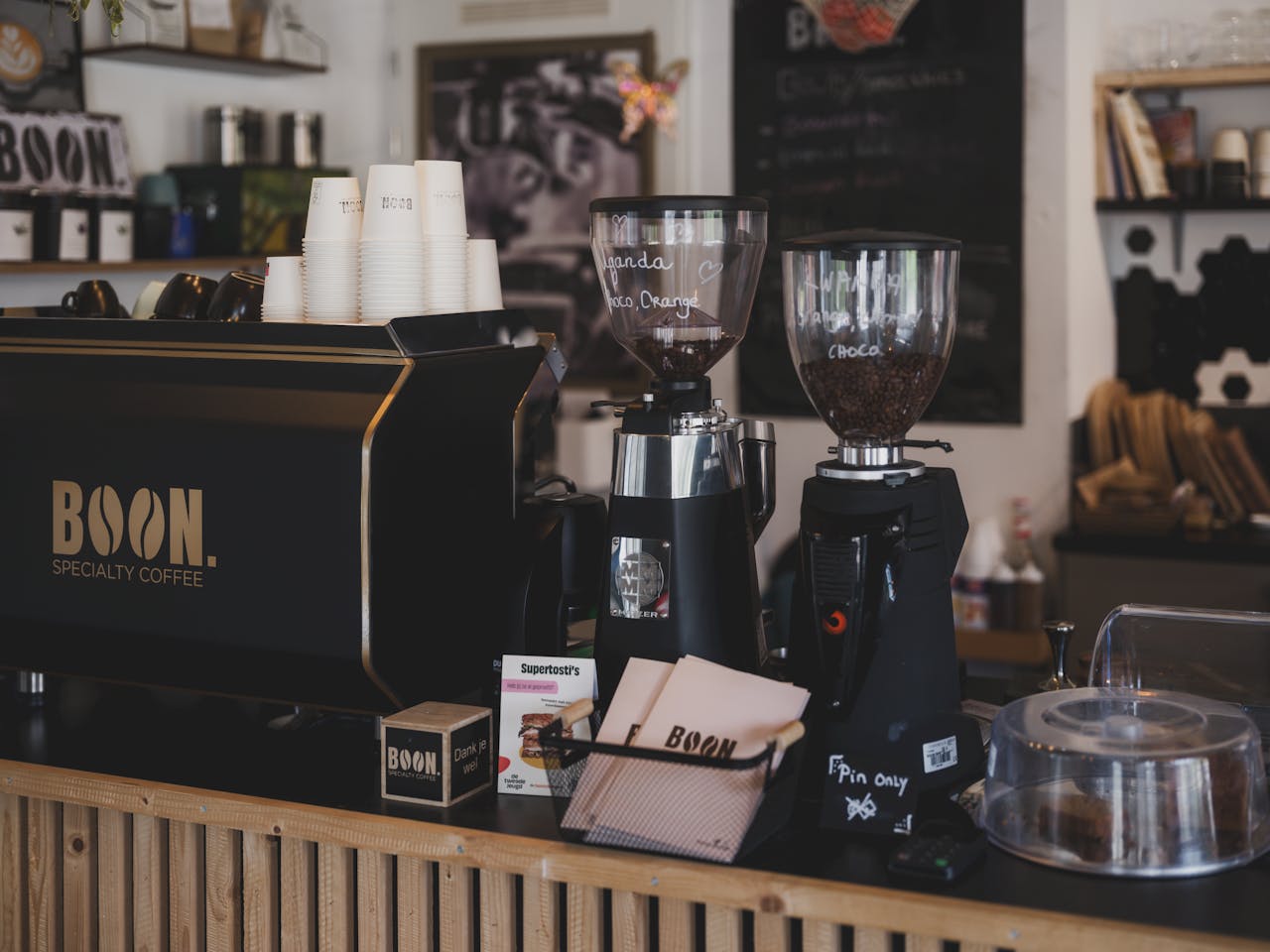 A warm coffee shop ambiance showcasing espresso machines and coffee accessories.